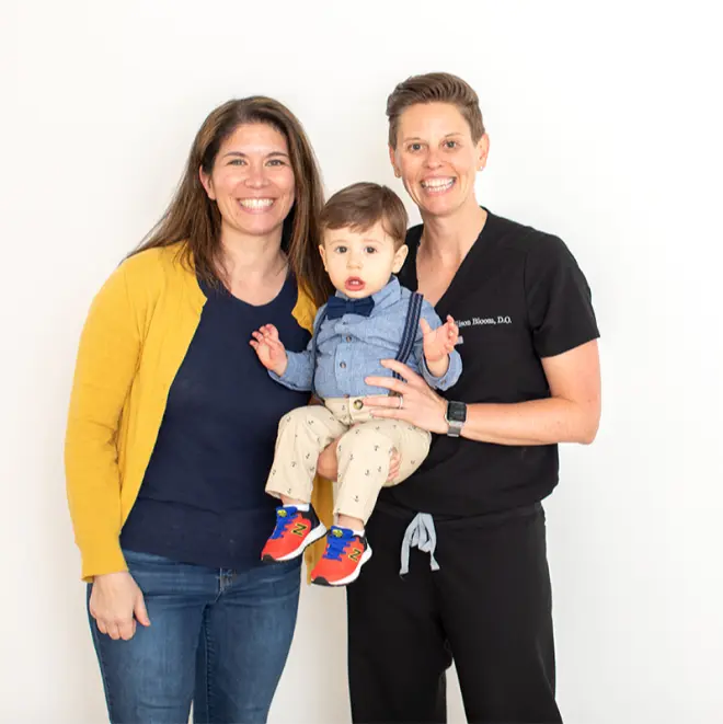 Dr. Bloom with a patient holding a little boy.